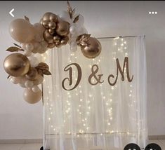 balloons are hanging from the ceiling in front of a sign that says d & m