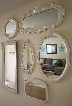 a living room with mirrors on the wall