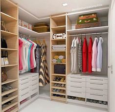 an organized closet with white drawers and shelves filled with clothes, bags and purses