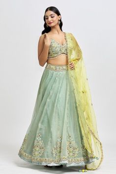 Fern green lehenga with placed zardozi embroidered floral jaal motifs highlighted by beads and pearls.  Comes with floral embroidered, pearl tasselled blouse and scalloped border dupatta. - Aza Fashions Green Floor-length Tissue Silk Lehenga, Green Tissue Silk Lehenga With Dori Work, Green Lehenga In Tissue Silk With Dori Work, Green Tissue Silk Lehenga For Reception, Green Tissue Silk Choli With Dori Work, Green Organza Lehenga With Gota Work, Green Organza Choli With Gota Work, Pista Green Tissue Silk Choli For Diwali, Pista Green Tissue Silk Lehenga With Sheer Dupatta