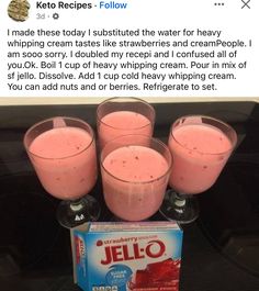 four glasses filled with pink jello sitting on top of a table next to a box of jello