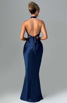 Feel opulent in Dimitra, a stunning maxi design crafted in delicate satin with a beautiful sheen and silky soft feel. Featuring a high cross over neckline and low back with tie detail, this style has a fit and flare silhouette and flattering piping under the bust. Keep things chic with barely there heels and sleek hair. 



Colour: Navy.

Premium non-stretch satin.

Shaped piping under bust.

Fit and flare silhouette.

High cross over neckline.

Tie detail to back.

Low back.

Invisible zipper t Back Free Dress, Low Back Prom Dress, Minimalist Heels, Backless Formal Dress, Outfit Club, Blue Formal Dress, Halter Backless Dress, Sleek Hair, Maxi Design