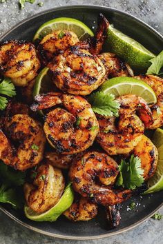 grilled shrimp with lime wedges and cilantro