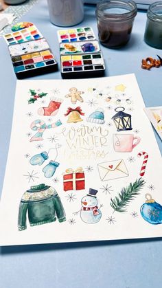 some watercolors and paints on a table with a card that says yummy winter wishes