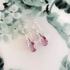 Swarovski Light Amethyst Dainty Earrings Sterling Silver/Light Pink Crystal Teardrop Earrings/Birthday Gift for Mum/June Birthstone Earrings Birthday Gift A gorgeous dainty earrings handcrafted using genuine high quality 11.5mm Swarovski pear cut crystal and colour is called Light Amethyst, which is a fabulous sparkly shade of light pink, simply stunning. These elegant dainty crystal teardrop earrings have a beautiful unique colour, with a subtle beautiful sparkle.  Light amethyst is the birthstone for the month of June and will make a meaningful and lovely birthday gift or for a special anniversary gift. Fantastic Mother's day present to give your Mum. These beautiful Earrings are fabulous for all occasions.  Details: Swarovski Light Amethyst pear cut crystals measuring 11.5mm x 8mm Sterl Elegant Lavender Crystal Earrings For Party, Sparkling Stone Teardrop Earrings, Amethyst Teardrop Crystal Earrings, Teardrop Crystal Earrings As A Gift, Crystal Teardrop Long Drop Earrings Gift, Delicate Teardrop Crystal Earrings For Parties, Sterling Silver Teardrop Earrings With Sparkling Stones For Gift, Elegant Briolette Crystal Earrings Gift, Elegant Teardrop Birthstone Earrings For Gift