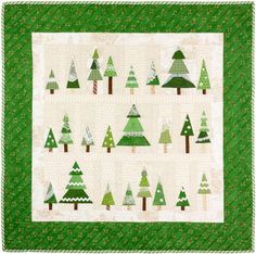 a green and white quilt with trees on it