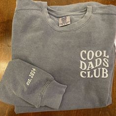 Hop into the exclusive circle where fashion and fun collide - welcome to the Cool Dads Club! Our embroidered club shirt is not just attire; it's your new badge of honor. Flaunting a sleek text design, it's for the dad who's as comfortable cracking a joke as he is fixing a bike. This isn't just a shirt; it's a statement that says, "I'm not a regular dad; I'm a cool dad." Embroidered Excellence for Everyday Heroes Crafted with precision, our Cool Dads Club shirt features detailed embroidery that m Father's Day Crew Neck Name Print T-shirt, Sporty Crew Neck T-shirt For Father's Day, Funny T-shirt For Father's Day Streetwear, Customizable Crew Neck T-shirt For Father's Day, Father's Day Unisex Crew Neck T-shirt, Hero Crafts, Everyday Heroes, Dad Fashion, Club Shirts