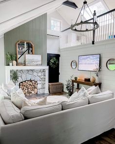 a living room filled with furniture and a fire place in the middle of an open floor plan