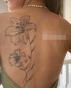 a woman with a flower tattoo on her back