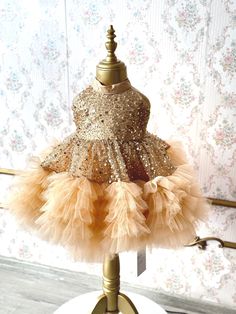 Our enchanting gold sequin tulle dress, is perfectly tailored for your little princess. This hand-crafted dress is made with high quality craftsmanship and perfect for your little one's any special occasion such as birthdays, weddings or for photoshoots. Also an ideal gift option for your family's new little member or for your loved ones' babies! ♥ If you want a custom design (in different color, size, fabric, model etc.), please contact us so we can create your dream piece together! * FABRIC: Gold Sequin and Tulle, for your little princess to shine like a star in her puffy yet light dress. * LINING: 100% Organic Soft Cotton (pre-washed and ironed), ensuring utmost comfort for your little one. * DETAILS: Seams are locked and reversed so that it will not touch your baby's skin and cause irr Gold Embellished Tulle Dress, Gold Princess Tulle Pageant Dress, Gold Tulle Princess Pageant Dress, Elegant Gold Princess Dress For Party, Elegant Gold Princess Dress With Ruffles, Gold Fitted Pageant Dress For Party, Gold Embellished Princess Dress, Gold Fitted Pageant Party Dress, Gold Dresses With Ruffles For Festive Occasions