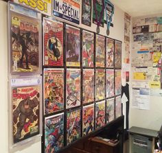 there are many comics on the wall in this room