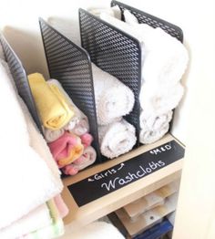 towels are stacked on top of each other in a rack with a sign that says girls and washcloths