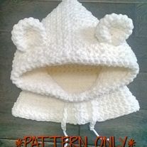 a crocheted white bear hat with the words pattern only written in orange on it