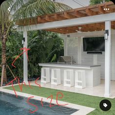 an outdoor kitchen and bar area next to a swimming pool