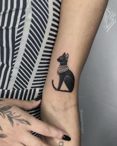 two people with matching tattoos on their hands and one has a cat tattoo on the wrist