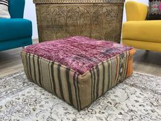 a colorful ottoman sitting on top of a rug