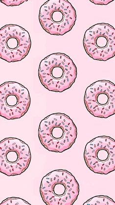 pink donuts with sprinkles on a light pink background seamless wallpaper