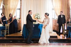 a bride and groom exchanging vows at their wedding reception