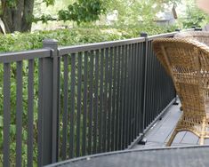 a wicker chair sitting on top of a wooden deck