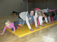 a group of women and children doing push ups