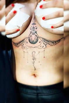 a woman's chest with tattoos on it and her hands holding something in the air