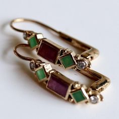 0.21 carats of diamonds set in 14k gold with garnet and emerald accents. European backs for pierced ears. Emerald And Diamond Earrings, Emerald Diamond Earrings, Replica Jewelry, Lapis Earrings, Zambian Emerald, Rhodolite Garnet, Emerald Earrings, Emerald Diamond, Jewelry Patterns