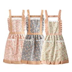 three different styles of aprons with floral print on the front and back, one in pink