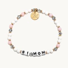 Little Words Project #1 Mom beaded elastic bracelet in dragon fruit bead design; white and pink beads with smoke gray translucent faux crystal beads with gold spacer beads and letter beads. Inspirational Bracelets For Mother's Day, New Mum Bracelet, Little Words Project, Cleaning Fun, Pet Parade, Mom Bracelet, Word Bracelet, Big Hug, Moms Bracelet