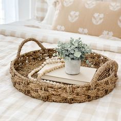 a wicker tray with a book and plant on it