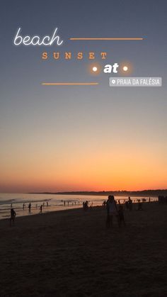 people are on the beach at sunset