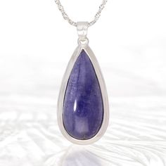 SpecificationsItem Code: SP1714Metric Dimensions: 48 x 21 x 11 mmImperial Dimensions: 2” x ¾” x ½”Weight: 75 Carats (15 grams) Unique QualitiesMeticulously crafted from sterling silver, this pendant features a stunning Tanzanite gemstone. A symbol of luxury and sophistication, this pendant is the perfect addition to any outfit. Bring a touch of elegance and exclusivity to your wardrobe. (Chain sold separately) Gemstone Properties, Tanzanite Gemstone, Gemstone Pendant, Silver Pendant, Jewelry Necklace Pendant, Etsy Accessories, Jewelry Necklaces, Accessory Gift, Gems