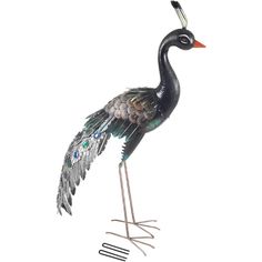 a metal bird with feathers and jewels on it's legs