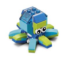 an octopus made out of legos sitting on top of a black surface with one eye open