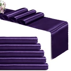 purple satin table runner with flowers on top