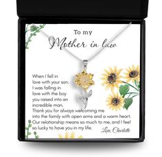 a mother's necklace with sunflowers on it in a black gift box