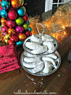 there is a plate of cookies on the table with christmas decorations in the back ground