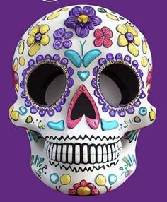 a white skull with colorful flowers on it's face and the words, day of the dead