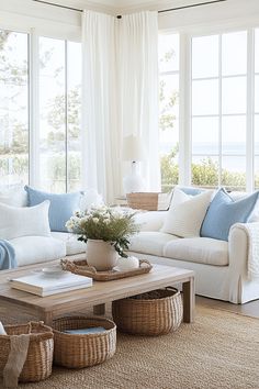 a living room filled with lots of furniture next to large window covered in white curtains