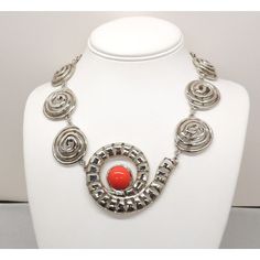 This is part of Chairish’s Costume Jewelry assortment.  1970s Modernist rhodium plated spiral links with cabochon faux-carnelian center and box clasp with a single clear round rhinestone on it necklace. Marked "U.C. Ugo Correani Made in Italy." Center:  2 inches long. Overall measures: 7 1/2 inches long by 5 1/2 inches wide. Interior circumference about 17 1/2 inches. Condition: Very good except that there is crazing to the metal coating on the clasp, which may be a problem at a later date, but Modern Red Cabochon Jewelry, Retro Round Metal Necklaces, Retro Round Metal Necklace, Modernist Round Cabochon Jewelry, Elegant Spiral Metal Jewelry, Formal Round Wire Wrapped Jewelry, Modern Spiral Jewelry For Formal Occasions, Modern Spiral Jewelry For Formal Events, Retro Silver Metal Necklace