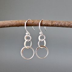 "Three graduated flat silver circles dangle from balled silver earwires. Looking for classic everyday silver earrings? These are perfect. So lightweight you'll hardly know you're wearing them! Top silver circle: 5mm Middle silver circle: 7mm Bottom silver circle: 10mm Total length of earrings: 1 1/8\" All silver is sterling. These earrings are also available in gold vermeil... www.etsy.com/listing/512525270/gold-circle-earrings As the owner, maker, designer, and curator of this shop, I take grea Simple Circle Nickel-free Earrings, Silver Single Circular Earring, Simple Sterling Silver Dangle Hoop Earrings, Simple Sterling Silver Pierced Earrings, Simple Nickel-free Metal Earrings, Simple Metal Jewelry For Pierced Ears, Simple Sterling Silver Nickel-free Earrings, Simple Nickel-free Sterling Silver Earrings, Simple Sterling Silver Dangle Jewelry