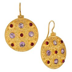 This ornamental geometric design, from the 6th century AD, is based on an original pendant disc crafted of gold filigree. Bejeweled with amethyst and garnet stones, the Museum reproductions are hand crafted of filigree wire. 24k gold vermeil. Size: 1 5/8" Elegant Gemstone Ceremonial Earrings, Elegant Ceremonial Gemstone Earrings, Opulent Gold Earrings As Gift, Opulent Gold Earrings Gift, Opulent Gold Earrings For Gift, Luxury Round Earrings For Ceremonial Occasions, Ceremonial Jeweled Yellow Gold Jewelry, Elegant Ceremonial Jeweled Earrings, Opulent Gold Jewelry With Matching Earrings