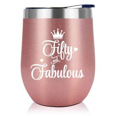 a pink wine glass with the words fifty and fabulous on it's side, sitting against a white background