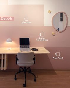 a laptop computer sitting on top of a wooden desk next to a wall mounted mirror