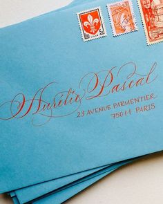 some blue envelopes with red ink on them