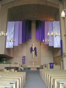 the inside of a church with pews and purple curtains