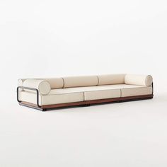 a white couch sitting on top of a wooden frame