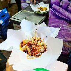 a person holding up a plate with food in it