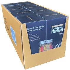 a cardboard box filled with canned food on top of a white background and an image of canning rings in it