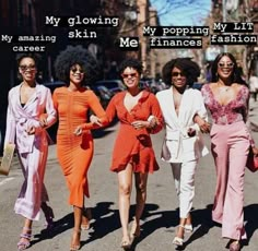 four women are walking down the street together