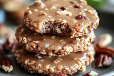 three cookies stacked on top of each other with pecans and nuts around the edges